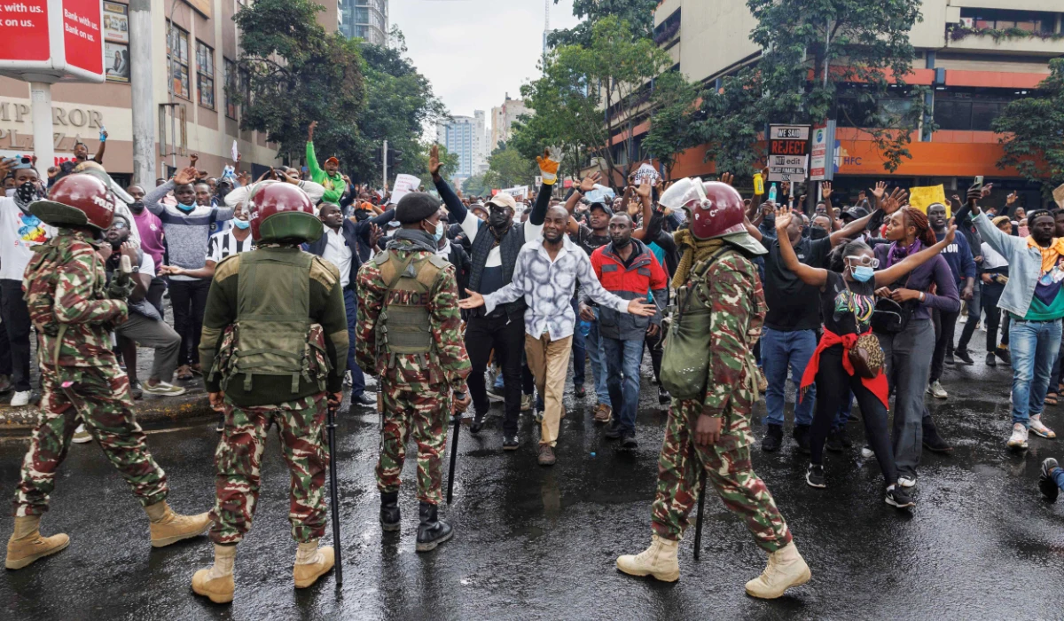 Protesters confront Kenyan anti-riot police officers during a demonstration against tax hikes, in the capital Nairobi on Thursday. (AFP)