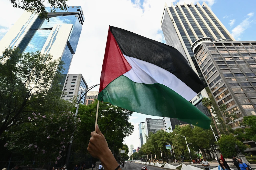 A demonstrator waves a flag of Palestine during a pro-Palestinian rally in front of the US embassy in Mexico City on June 1, 2024. (AFP)