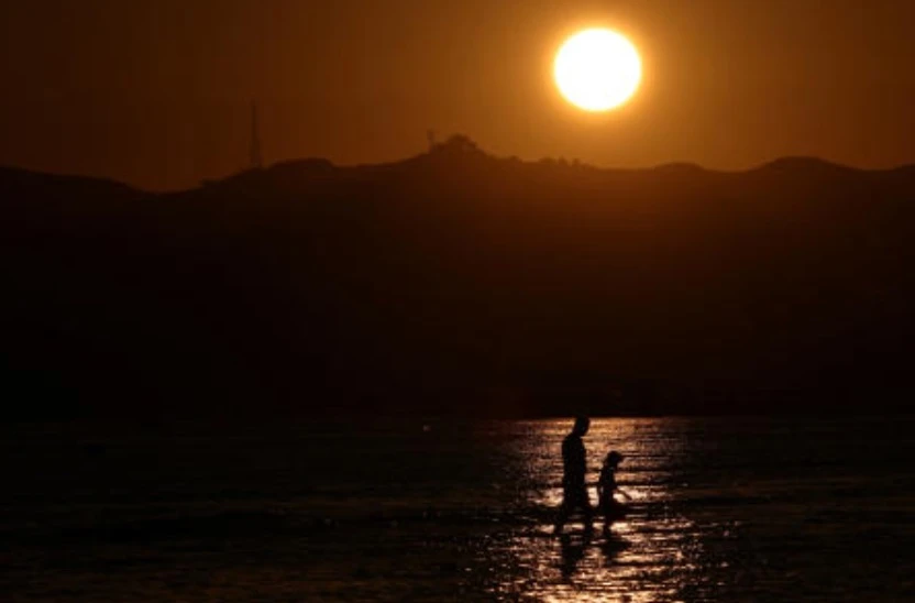 People enjoy the sea during the heat wave in Durres, Albania, June 18, 2024. (Reuters)