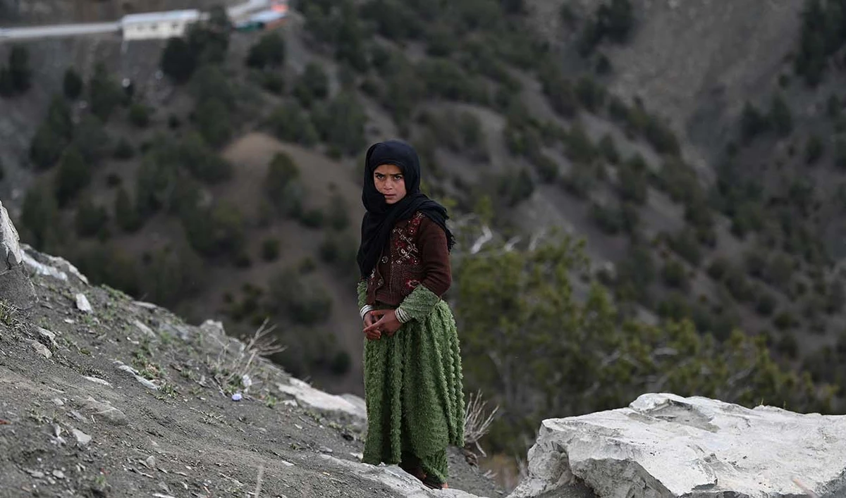 An Afghan girl stands along a hilltop in Sato kandaw area on the outskirts of Gardez, the capital of Paktia province on April 21, 2024. (AFP/File)