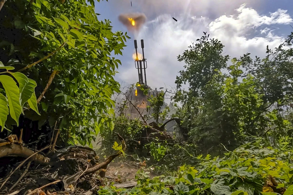 Above, Russian soldiers fire an anti-aircraft gun at an undisclosed location in Ukraine on June 21, 2024. (Russian Defense Ministry Press Service via AP)