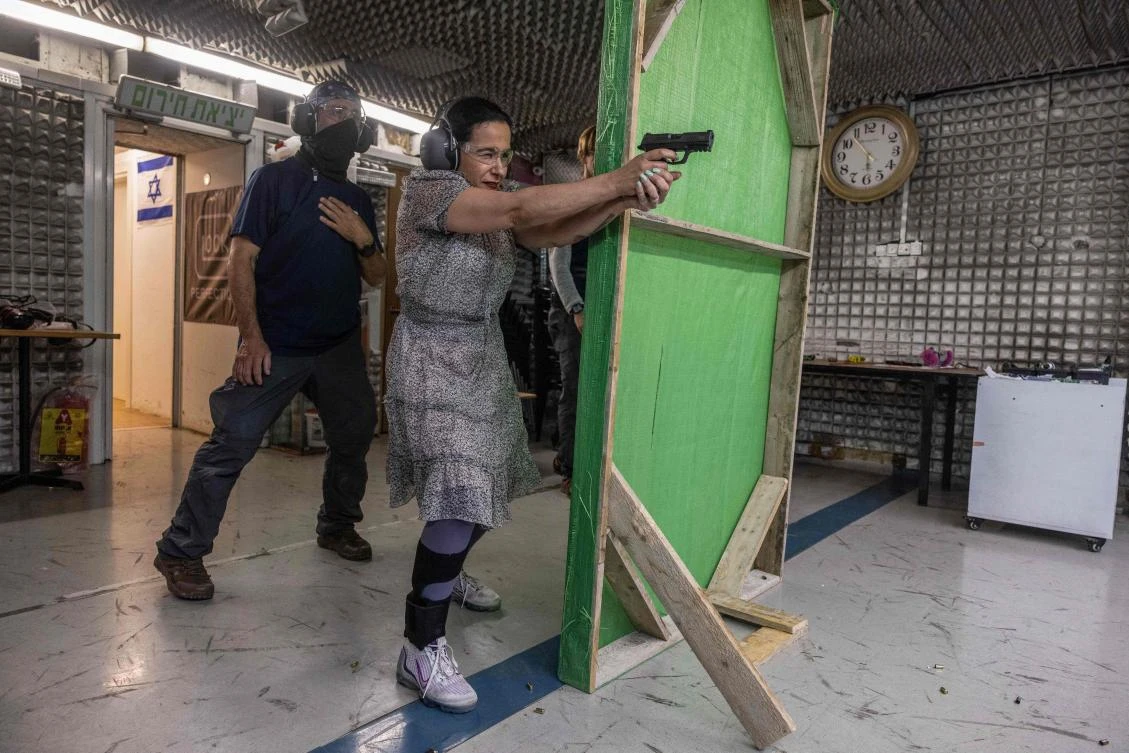 A picture taken on May 23, 2024, shows Limor Gonen practicing with a gun at a shooting range in the Israeli settlement of Ariel Ariel in the Israeli occupied Palestinian West Bank. (AFP)