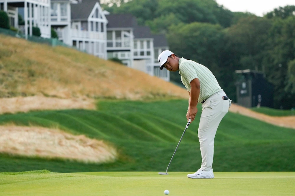 Tom Kim putts on the 12th green during the third round of the Travelers Championship golf tournament at TPC River Highlands, Saturday in Cromwell, Conn. (AP)