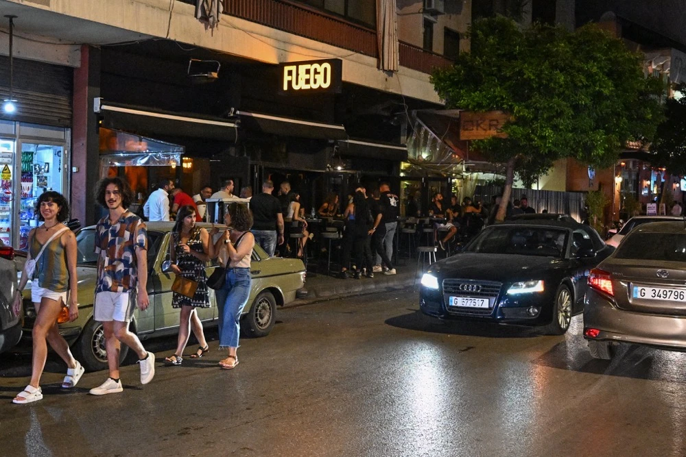 Revelers drink at a pub on a busy nightlife street in Beirut's Mar Mikhail neighbourhood on June 22, 2024. (AFP)
