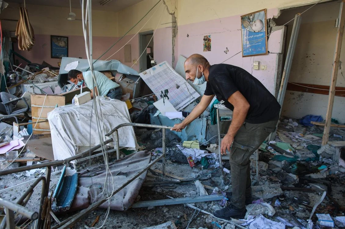 Palestinians inspect the rubble at the Al-Daraj clinic in Gaza City after it was hit in an Israeli strike a day earlier on June 24, 2024, amid the ongoing battle between Israel and the Palestinian militant group Hamas. (AFP)