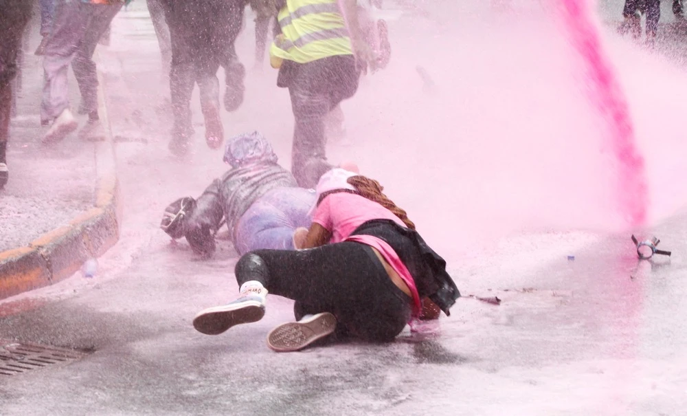 People fall as they run after police use water cannon to disperse protesters during a demonstration against Kenya's proposed finance bill 2024/2025 in Nairobi, Kenya. (Reuters)