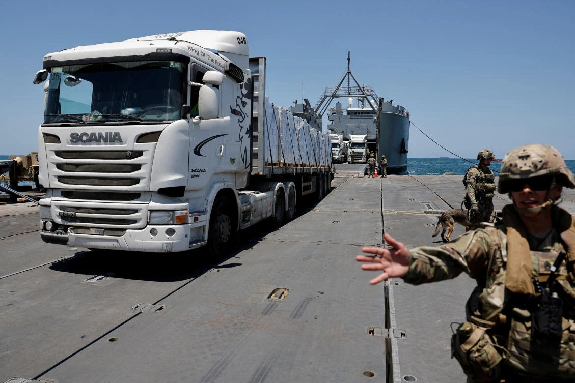 A truck carries humanitarian aid across Trident Pier, a temporary pier to deliver aid, off the Gaza Strip, near the Gaza coast, on Jun. 25, 2024. (Reuters)