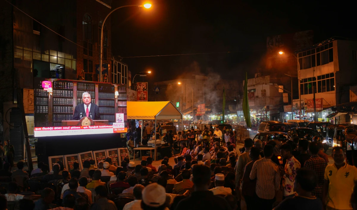 Supporters of Sri Lanka’s President Ranil Wickremesinghe watch a televised speech in Colombo, Sri Lanka, Wednesday, June 26, 2024. (AP)