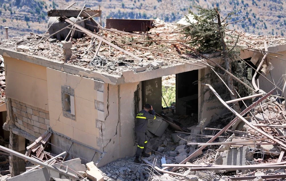 A civil defense worker inspects a destroyed house that was hit by an Israeli airstrike, in Chebaa, a Lebanese town near the border with Israel, south Lebanon, Wednesday, June 26, 2024. (AP Photo)