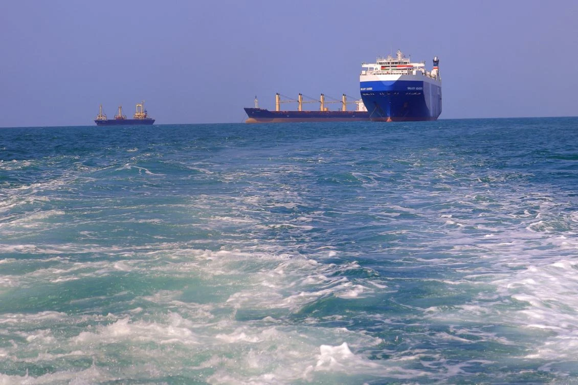 A picture taken during an organized tour by Yemen’s Houthi rebels on Nov. 22, 2023 shows the Galaxy Leader cargo ship, right, seized by Houthi fighters approaching the port in the Red Sea off Yemen’s province of Hodeidah. (AFP)