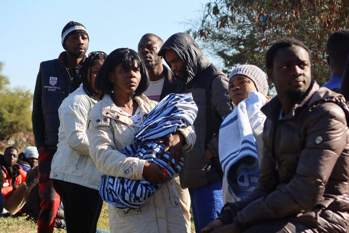 Ivory Coast nationals living in Tunisia and seeking repatriation, wait outside the embassy of Ivory Coast in Tunis. (Reuters)