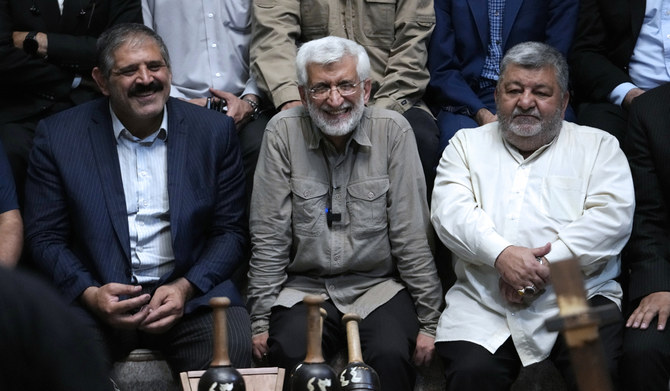 Candidate for the presidential election Saeed Jalili, center, a former Iranian top nuclear negotiator, smiles in a meeting with a group of athlete supporters during his campaigns at a sport hall in Tehran, Iran, on June 30, 2024. (AP)