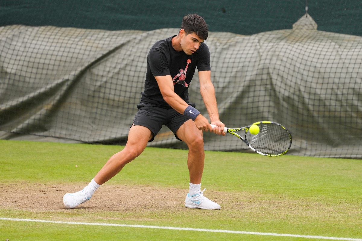 Spain's Carlos Alcaraz plays a backhand return during a practice session ahead of their first round match of the Wimbledon tennis championships in London. (AP)