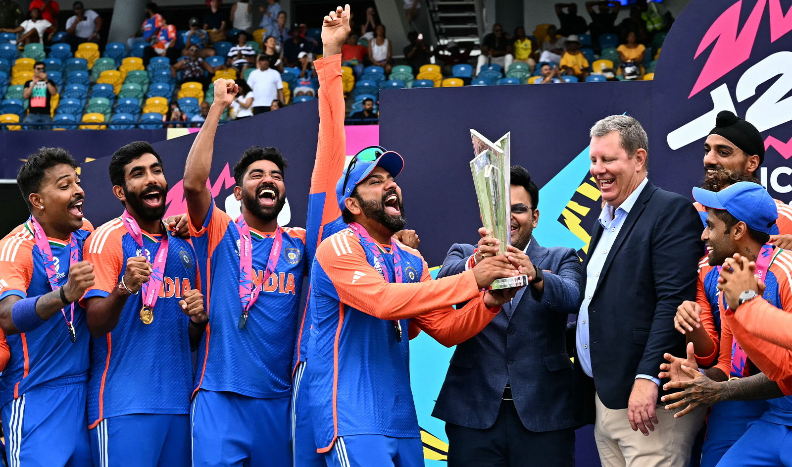 India's captain Rohit Sharma (4th L) and Jay Shah (4th R), Secretary of the Board of Control for Cricket in India (BCCI), accept the trophy from Greg Barclay (3rd R), chairman of the International Cricket Council (ICC), as Team India celebrates after winning the ICC men's Twenty20 World Cup 2024 final cricket match against South Africa in Bridgetown, Barbados, on June 29, 2024. (AFP)