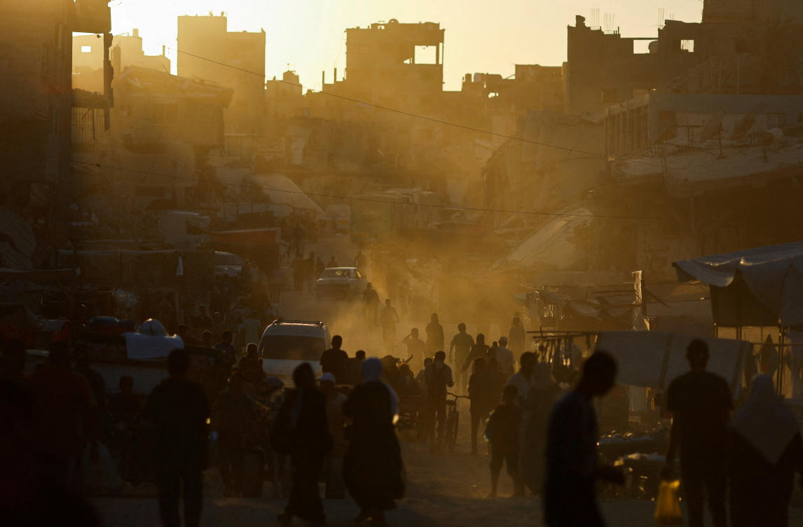 Above, residents walk at the remains of a market after an Israeli strike in Khan Younis of southern Gaza Strip on June 30, 2024. (Reuters)