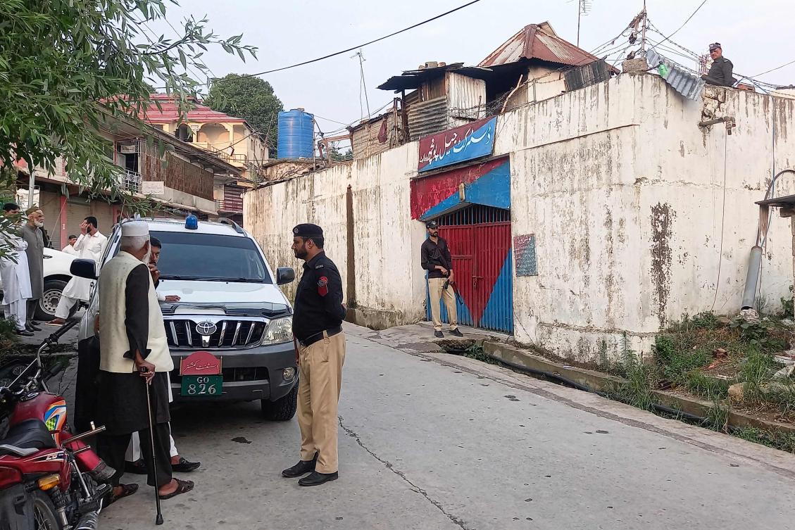 Policemen stand guard after the detainees’ prison break in Poonch district jail in Rawalakot city of Pakistan-administered Kashmir on June 30, 2024. (AFP)