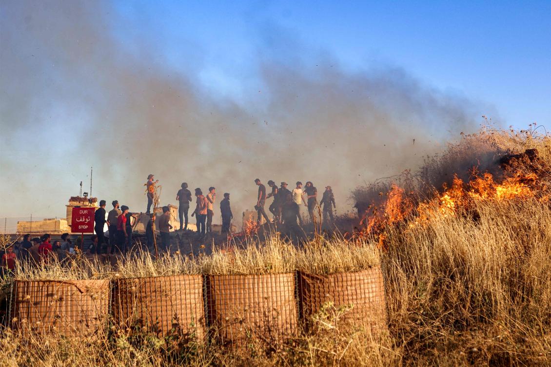 Syrian demonstrators protest near a Turkish army observation point in Ibbin Samaan in the western part of Syria’s northern Aleppo province on July 1, 2024. (AFP)