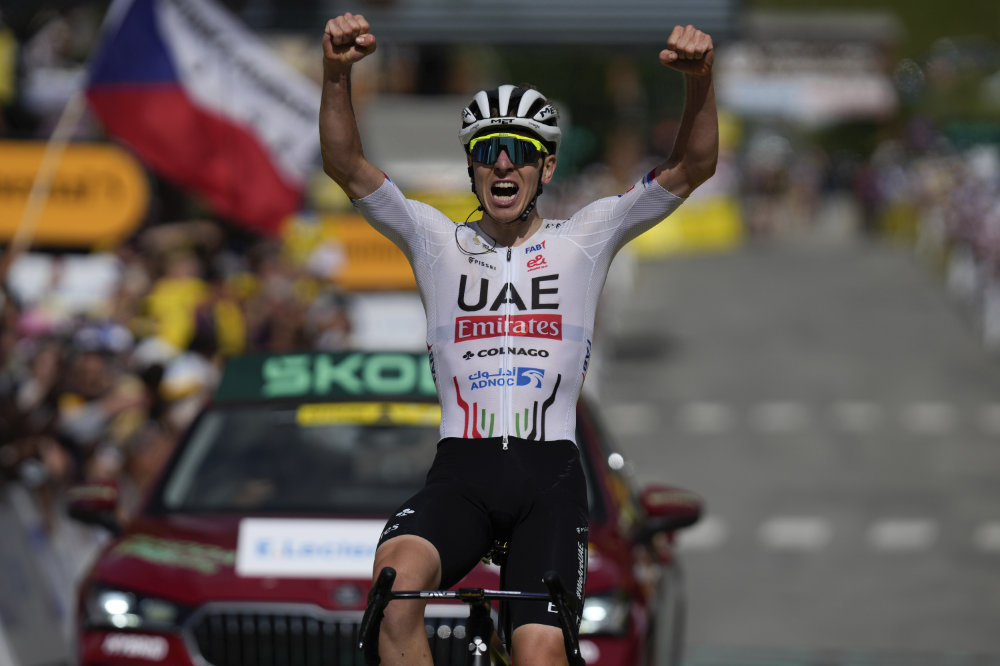 Slovenia's Tadej Pogacar celebrates as he crosses the finish line to win the fourth stage of the Tour de France cycling race over 139.6 kilometers (86.7 miles) with start in Pinerolo, Italy and finish in Valloire, France, Tuesday. (AP)