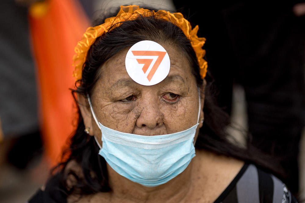 Above, a Move Forward Party supporter attends a protest on July 19, 2023. The party continues to be popular among Thai voters, polling at 49.2 percent in a recent opinion survey lat month. (AFP file photo)