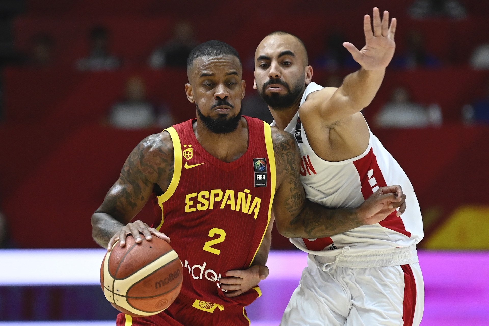 Spain's guard #02 Lorenzo Brown drives against Lebanon's guard #10 Ali Mansour during the 2024 FIBA Olympic Qualifying Tournament basketball match between Finland and Bahamas in Valencia, on July 2, 2024. (AFP)