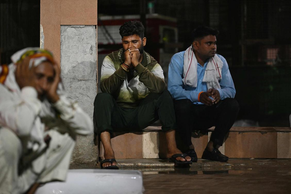 Above, relatives sit outside the morgue of a hospital in Hathras in India’s Uttar Pradesh state on July 3, 2024, following a stampede during a Hindu religious gathering. Deadly incidents are common at places of worship during major religious festivals in India. (AFP)