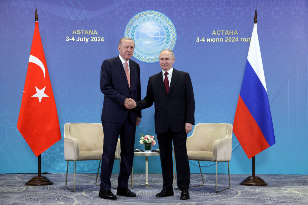 Russian President Vladimir Putin shakes hands with Turkish President Tayyip Erdogan during a meeting on the sidelines of the Shanghai Cooperation Organization (SCO) summit in Astana, Kazakhstan, on July 3, 2024. (Sputnik/Gavriil Grigorov/Pool via REUTERS)