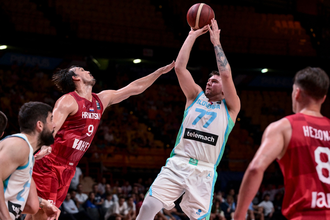 Slovenia's Luka Doncic jumps to score in front of Croatia's Dario Saric during an Olympic Qualifying Tournament at the Peace and Friendship Stadium in Athens. (AFP)