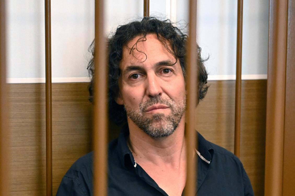 (FILES) Laurent Vinatier, a French national who works with a Swiss-based conflict mediation non-profit organization, looks on as he sits in the defendant’s cage during his pre-trial detention hearing in Moscow on June 7, 2024.(AFP)