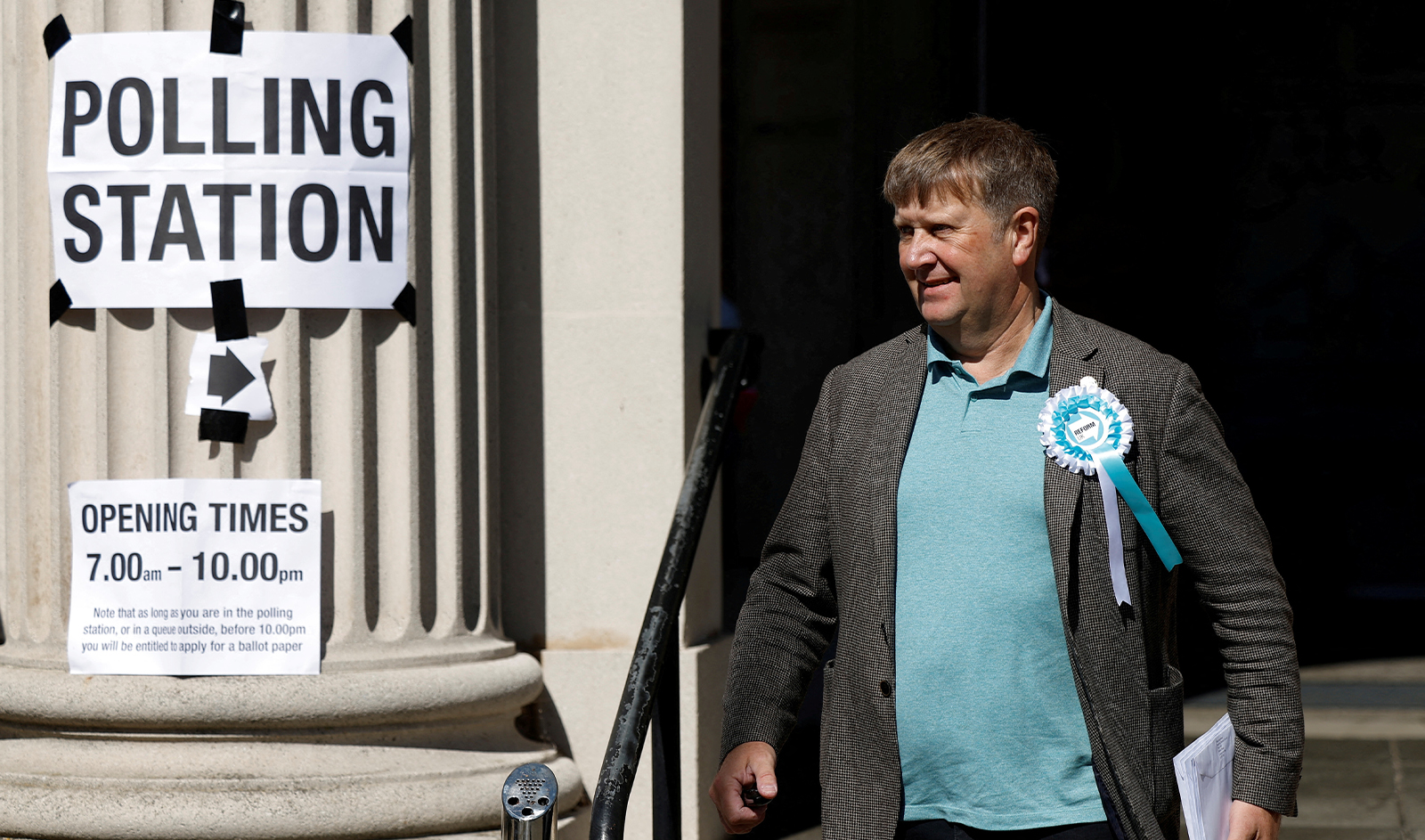 A Reform UK party worker walks outside a polling station during the general election in Clacton-on-Sea, Britain, on July 4, 2024. (REUTERS)