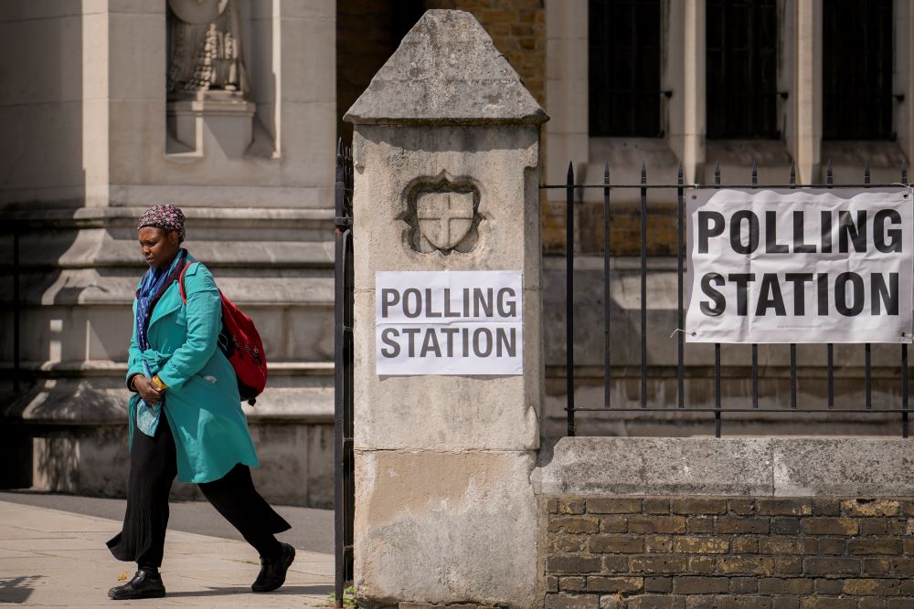 A woman exits a polling station at St. George’s Cathedral in London, Thursday, July 4, 2024. (AP Photo)