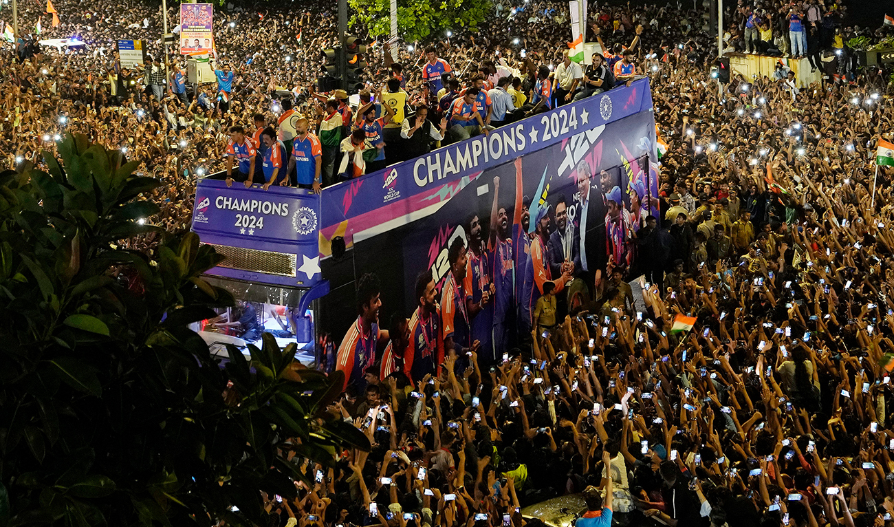 Crowds surround a double-decker bus as the India cricket team takes part in a parade celebrating their T20 Cricket World Cup win, in Mumbai on July 4, 2024. (AP)