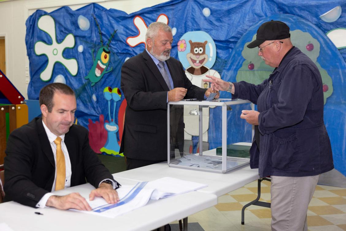 A voter casts his ballot during the second round of the French parliamentary elections, at a polling station in Saint-Pierre, in the French northern Atlantic archipelago of Saint-Pierre-et-Miquelon, on Jul. 6, 2024. (AFP)