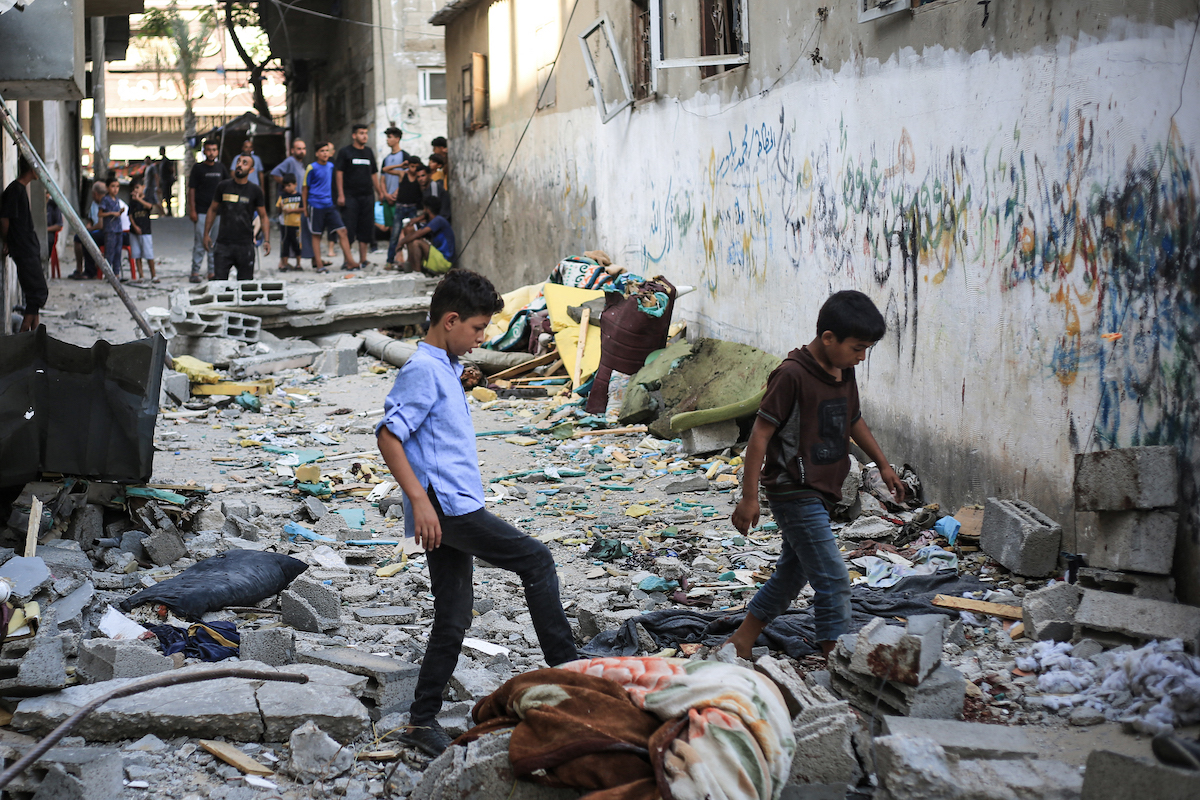 Palestinians asses the damage following an Israeli strike in the Nuseirat refugee camp in the central Gaza Strip on July 6. (File/AFP)