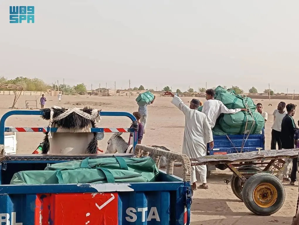 Sudanese carry their share of goods distributed by KSrelief in the Nile River State. (SPA)