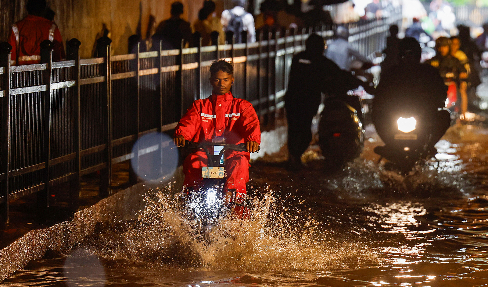 A delivery person rides an electric scooter in a waterlogged subway after heavy rains in Mumbai, India, on July 8, 2024. (REUTERS)