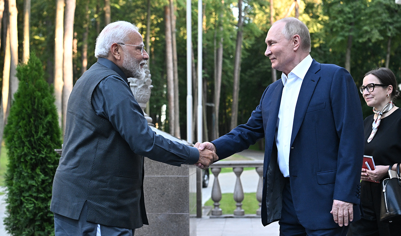 In this pool photograph distributed by the Russian state agency Sputnik, Russia's President Vladimir Putin welcomes Indian Prime Minister Narendra Modi for an informal meeting at the Novo-Ogaryovo state residence, outside Moscow, on July 8, 2024. (AFP)