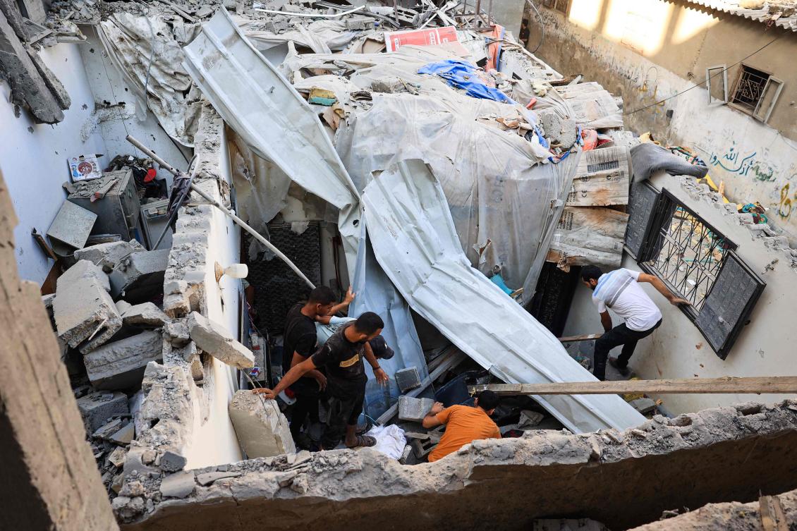 Palestinians asses the damage following an Israeli strike in the Nuseirat refugee camp in the central Gaza Strip on July 6, 2024. The health ministry in Hamas-run Gaza said on July 6 that at least 38,098 people have been killed in nine months of war between Israel and Palestinian militants. (AFP)