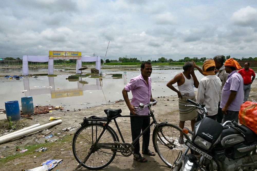 People gather near the site in the aftermath of a stampede at Hathras in India’s Uttar Pradesh state on July 4, 2024, where 121 people died. (AFP)