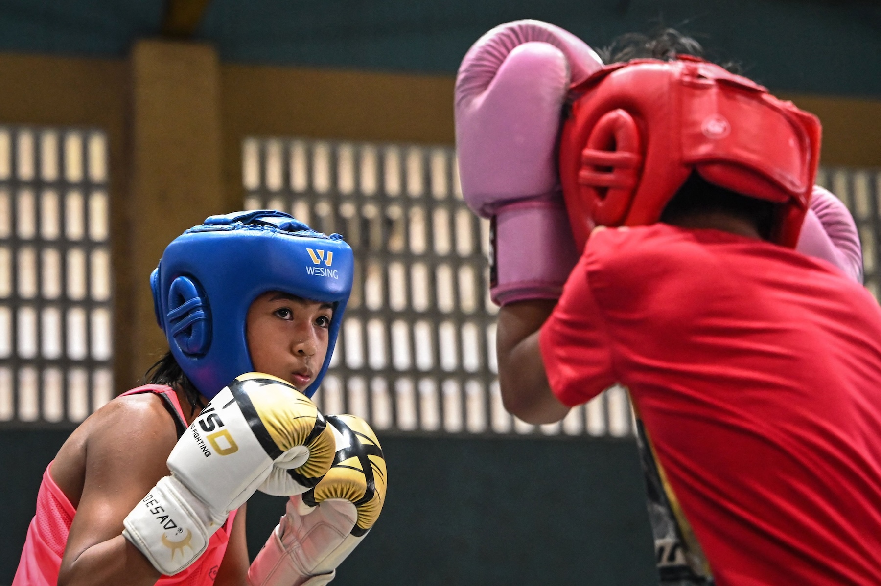 This photo taken on June 5, 2024 shows Prystine Niche Cantancio (L) sparring during training at a boxing gym in Bago City, Negros Occidental province. (AFP)