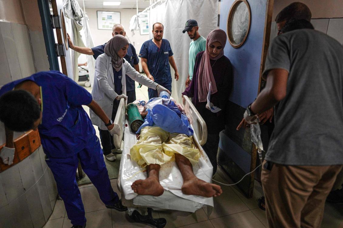 Medics give aid to a man lying a gurney, injured during Israeli bombardment, as he is brought to the Nasser Hospital in the city of Khan Yunis, in the southern Gaza Strip on July 6, 2024, amid the ongoing conflict between Israel and the Palestinian Hamas militant group. (AFP)