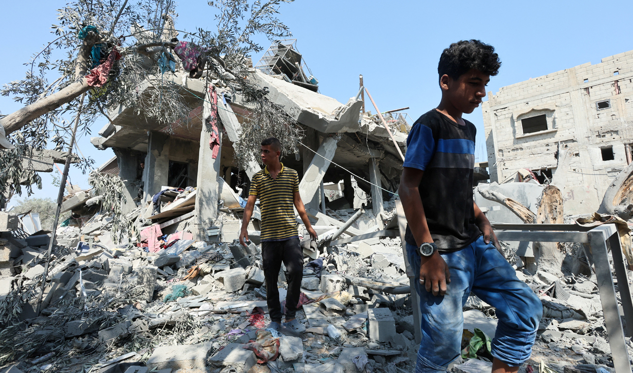 Palestinians inspect a house destroyed in an Israeli strike, amid the Israel-Hamas conflict, in Nusairat refugee camp, in the central Gaza Strip on July 9, 2024. (REUTERS)