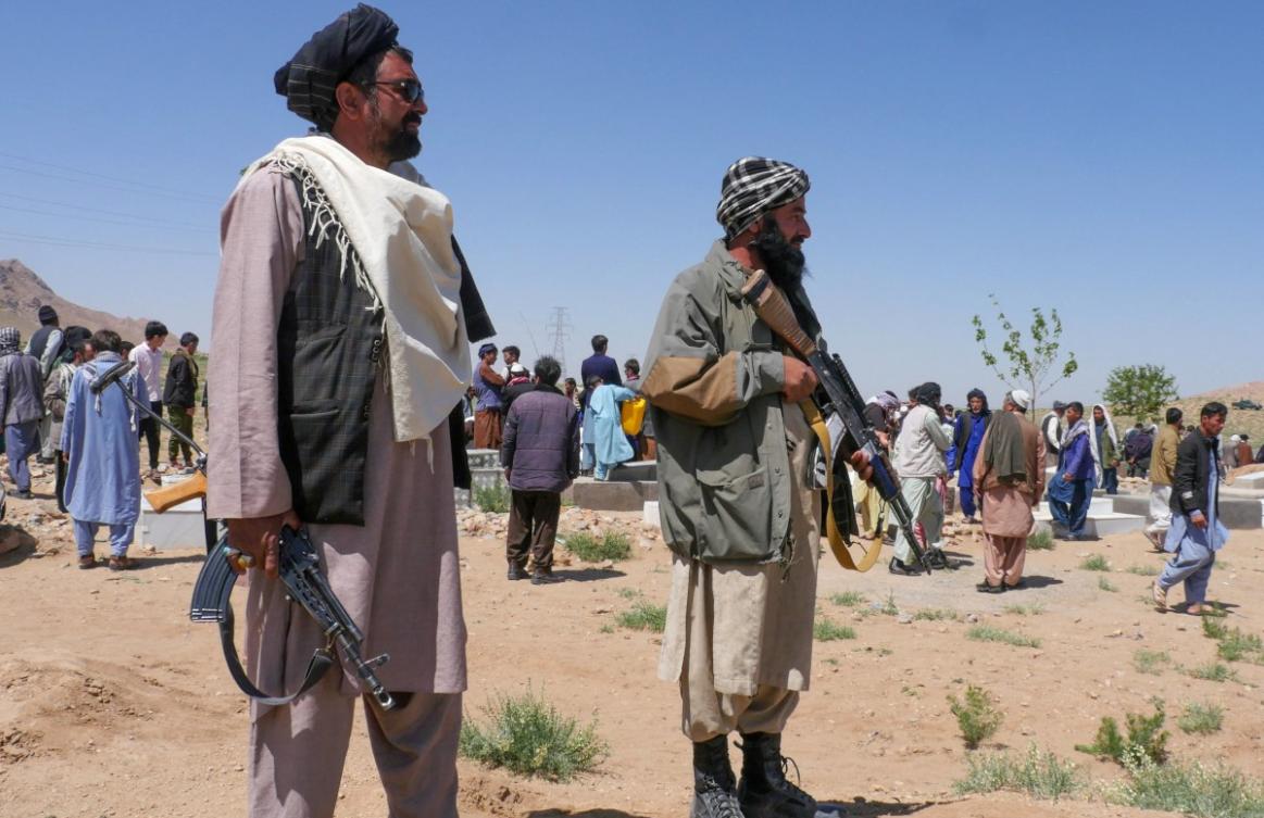 Taliban security personnel stand guard as Afghans mourn at a burial ceremony of the slain Shiite Muslims after gunmen attacked a mosque in Guzara district of Herat province on April 30, 2024. (AFP)