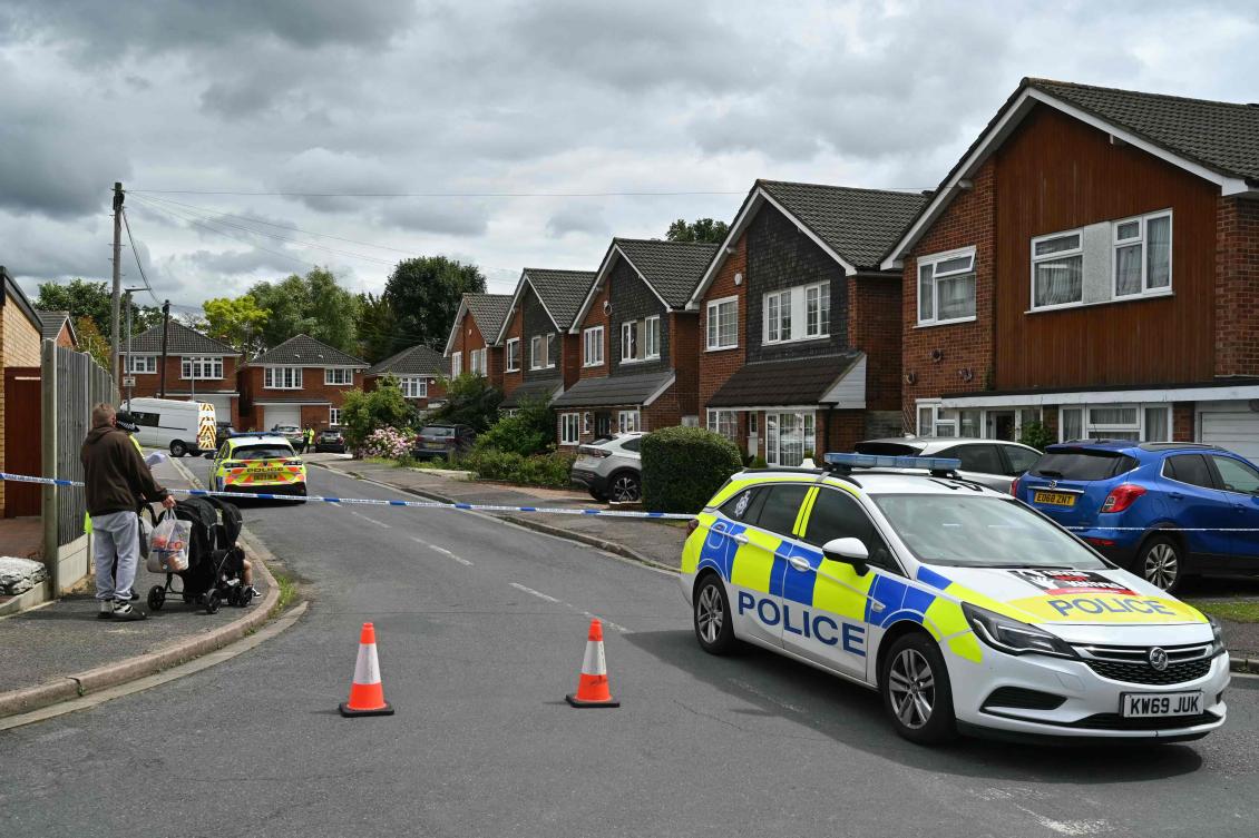 A police car is parked by Ashley Close in Bushey in the borough of Hertfordshire, north of London, on Jul. 10, 2024 after a triple “crossbow attack” murder. (AFP)