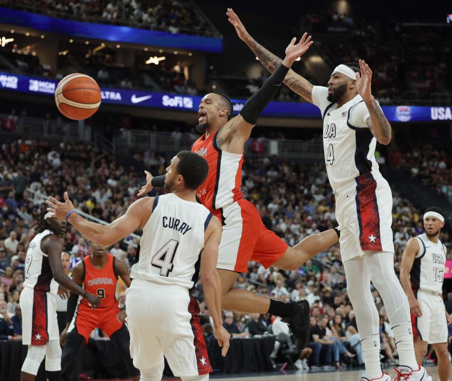 Dillon Brooks of Canada is fouled by Stephen Curry of the United States as Anthony Davis defends in their exhibition game on July 10, 2024 ahead of the Paris Olympic Games. (Getty Images/AFP)