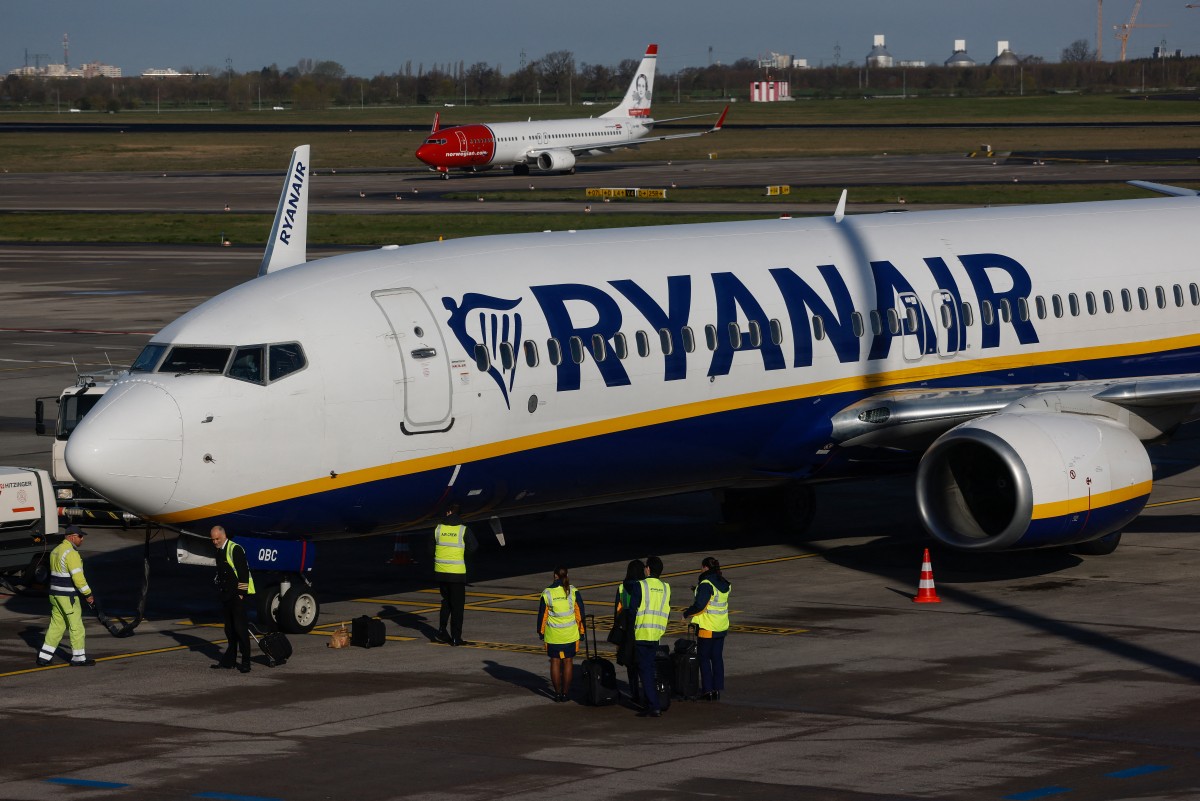 Video footage shared online shows passengers screaming, pushing and throwing punches in the aisle as cabin crew attempted to intervene. (AFP/File)