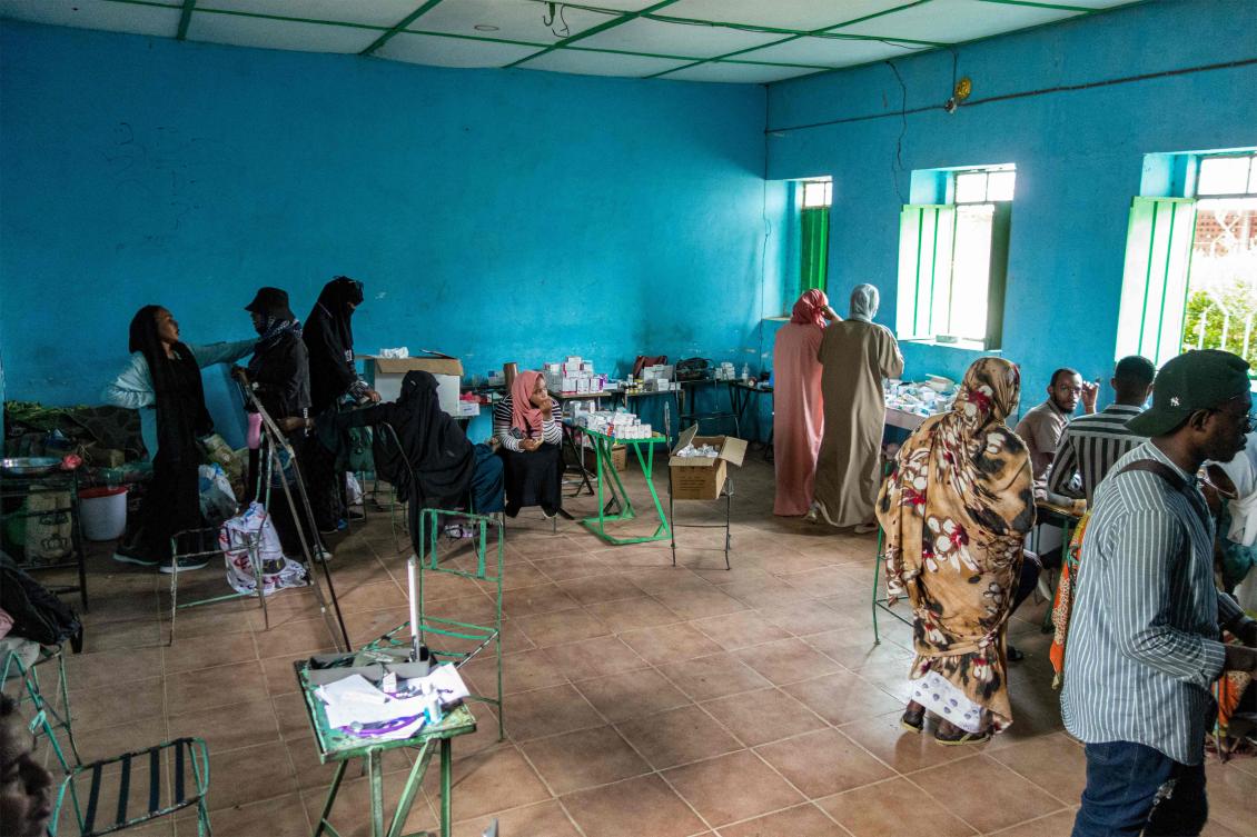 Volunteers dispense medication at a make-shift emergency clinic serving people displaced by conflict from Singa, Sennar, and Dinder, at a former technical education school building in Kassala in eastern Sudan on Jul. 6, 2024. (AFP)