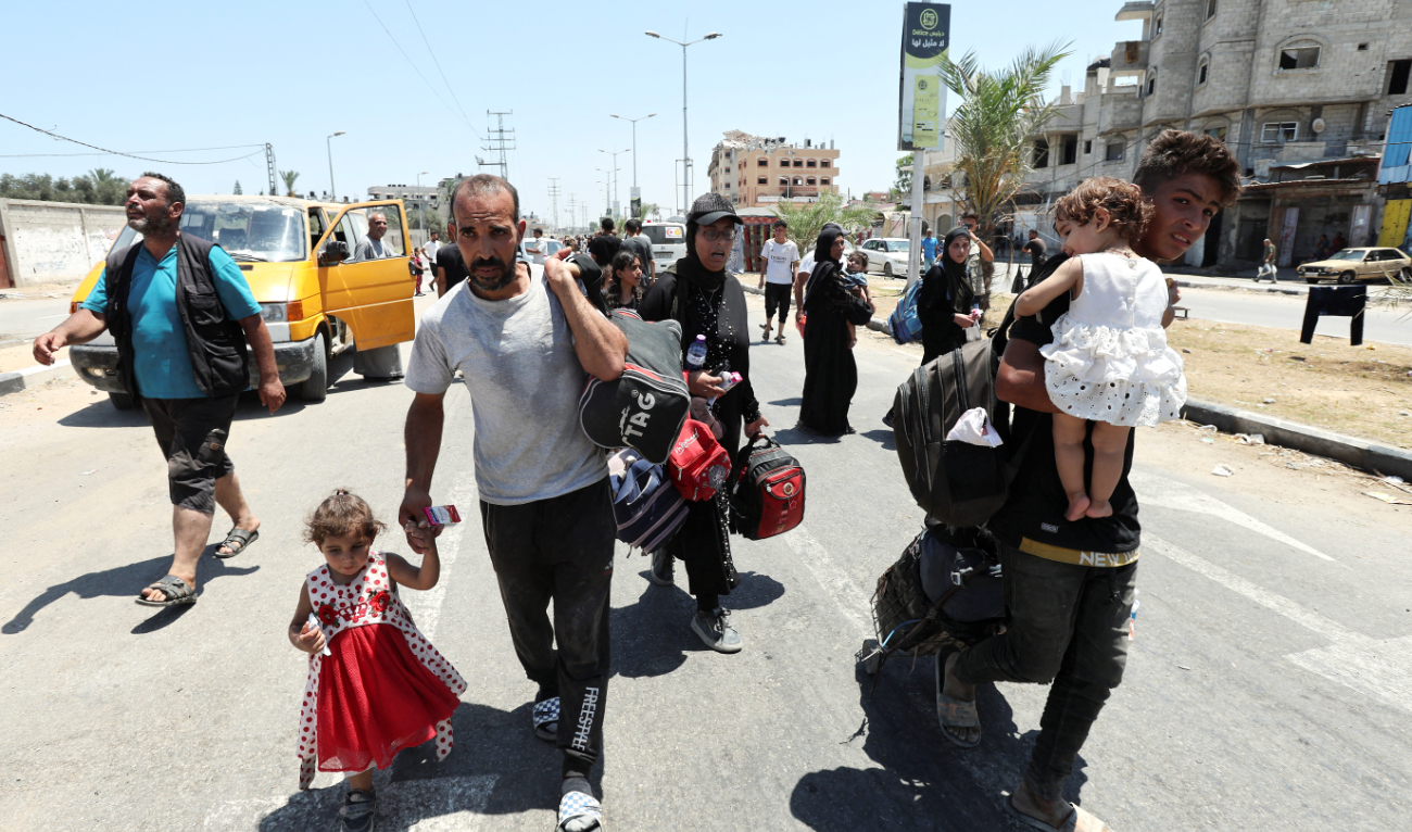 Displaced Palestinians arrive in Nuseirat in the central Gaza Strip on Thursday. They were forced to flee north Gaza because of Israeli army directives. (Reuters)