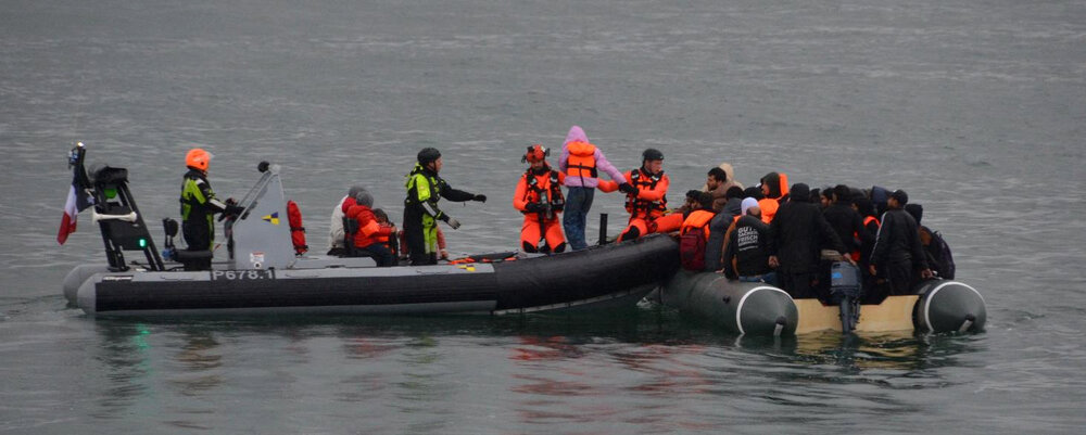 This handout photograph released by France’s Prefecture Maritime on July 12, 2024, shows rescuers assisting migrants from an inflatable dinghy off the coast of Boulougne-sur-Mer, northern France, after four migrants drowned overnight in The English Channel. (AFP)
