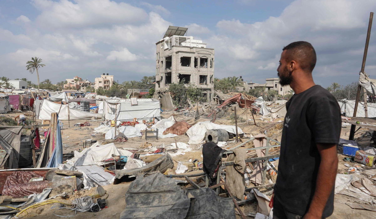 A Palestinian man looks at damaged tents at the site of Israeli bombardment a day earlier on the al-Mawasi displacement camp of Khan Yunis city in the southern Gaza Strip on July 14, 2024, amid the ongoing conflict between Israel and the Palestinian militant Hamas group in Gaza. (AFP)