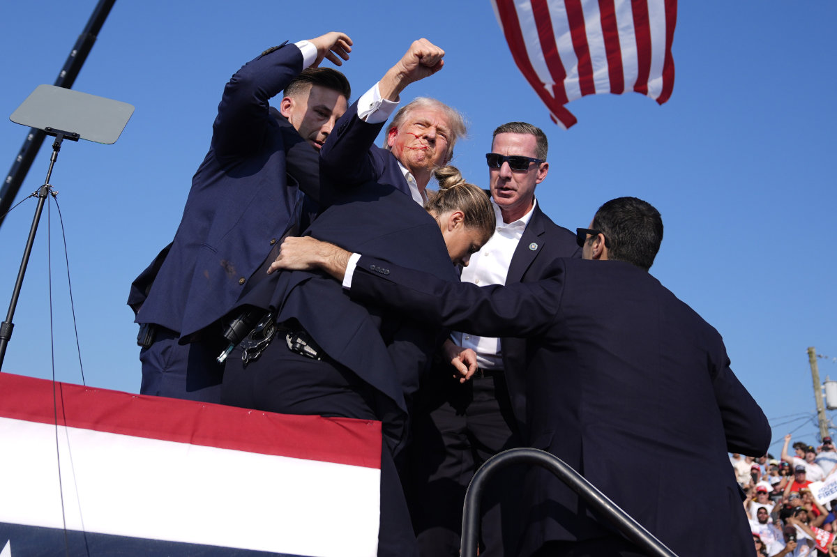 With his fist raised in a salute of defiance, a wounded Trump entered the iconography of American history in Butler, Pennsylvania. (Evan Vucci/AP)